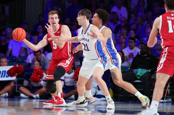 In a photo provided by Bahamas Visual Services, Wisconsin's Tyler Wahl (5) passes the ball during an NCAA college basketball game against Kansas in the Battle 4 Atlantis at Paradise Island, Bahamas, Thursday, Nov. 24, 2022. (Tim Aylen/Bahamas Visual Services via AP)