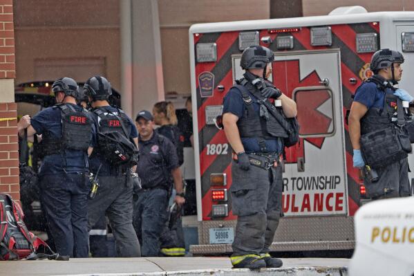 Law enforcement wait outside after a deadly shooting Sunday, July 17, 2022, at the Greenwood Park Mall, in Greenwood, Ind. (Kelly Wilkinson/The Indianapolis Star via AP)