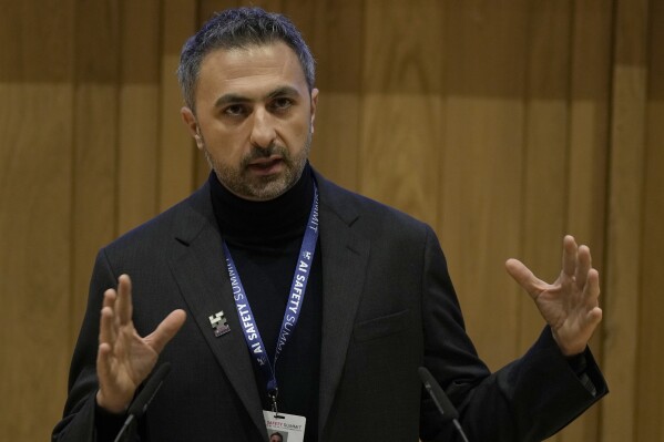 FILE - Mustafa Suleyman co founder and CEO of Inflection AI speaks to journalist during the AI Safety Summit in Bletchley Park, Milton Keynes, England, Wednesday, Nov. 1, 2023. Microsoft has hired Suleyman to head up its consumer artificial intelligence business, adding to its ranks an influential figure in the artificial intelligence world to cement its position at the forefront of the booming AI industry. Suleyman said in a post on LinkedIn on Monday, March 18, 2024, that he'll become CEO of Microsoft AI, leading all of the company's consumer AI products and research, including its generative AI service Copilot as well as its Bing search engine and Edge browser. (AP Photo/Alastair Grant, File)