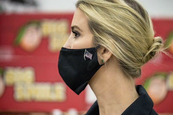 Ivanka Trump, the daughter of President Donald Trump, wears an American flag pin on her mask as she tours Coastal Sunbelt Produce, Friday, May 15, 2020, in Laurel, Md. (AP Photo/Andrew Harnik)
