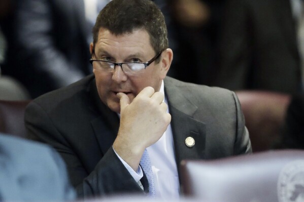 FILE - Indiana Rep. Jim Lucas, R-Seymour, listens during the start of the General Assembly session at the Statehouse, Jan. 3, 2018, in Indianapolis. A police report says the lawmaker’s pickup truck veered down a hill, across traffic lanes and through a guardrail on an interstate highway before he was arrested on a drunken driving charge. The prosecutor in southern Indiana’s Jackson County said Monday, June 5, 2023, that he had not yet decided about criminal charges against Lucas. (AP Photo/Darron Cummings, File)