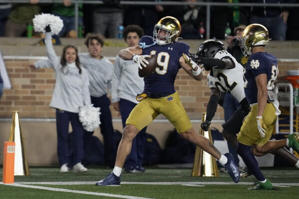 Notre Dame wide receiver Jaden Greathouse (19) breaks away from Wake Forest defensive back Demarcus Rankin (22) to score a touchdown during the second half of an NCAA college football game in South Bend, Ind., Saturday, Nov. 18, 2023. (AP Photo/Michael Conroy)