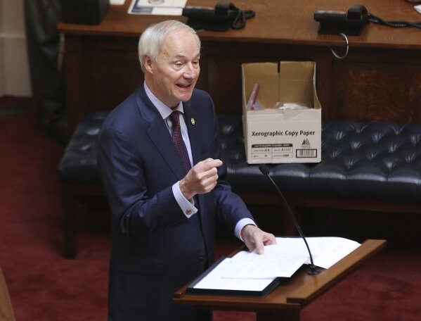 FILE - In this April 8, 2020 photo, Arkansas Gov. Asa Hutchinson gives the State of the State in the senate chamber of the state Capitol in Little Rock, Ark. Hutchinson vetoed legislation that would have made his state the first to ban gender confirming treatments for transgender youth. (Tommy Metthe/Arkansas Democrat-Gazette via AP, File)