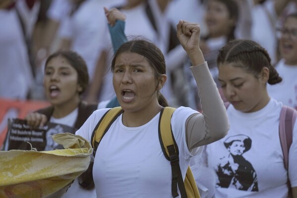 Relatives and sympathizers of 43 missing Ayotzinapa university students march on the 9th anniversary of their disappearance, in Mexico City, Tuesday, Sept. 26, 2023. (AP Photo/Marco Ugarte)