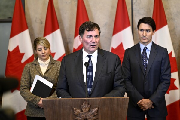 Minister of Public Safety, Democratic Institutions and Intergovernmental Affairs Dominic LeBlanc, centre, Prime Minister Justin Trudeau, right, and Minister of Foreign Affairs Melanie Joly participate in a news conference on the investigative efforts related to violent criminal activity occurring in Canada with connections to India, on Parliament Hill in Ottawa, on Monday, Oct. 14, 2024. (Justin Tang/The Canadian Press via AP)