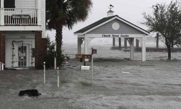 
              High winds and water surround buildings as Hurricane Florence hits Front Street in downtown Swansboro N.C., Friday, Sept. 14, 2018. (AP Photo/Tom Copeland)
            