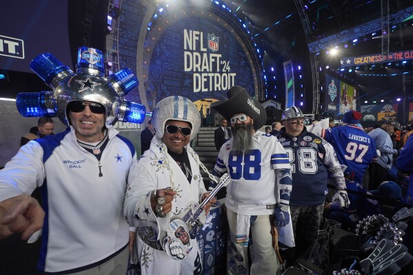 Dallas Cowboys fans pose ahead of the first round of the NFL football draft, Thursday, April 25, 2024, in Detroit. (AP Photo/Paul Sancya)
