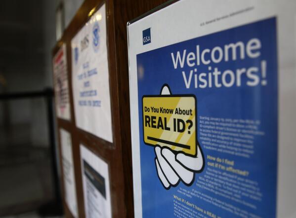 FILE - A sign at the federal courthouse in Tacoma, Wash., is shown on April 6, 2016, to inform visitors of the federal government's REAL ID Act, which requires state driver's licenses and ID cards to have security enhancements and be issued to people who can prove they are legally in the United States. The deadline for obtaining the Real ID needed to board a domestic flight has been pushed back again, with the Department of Homeland Security citing the lingering impact of the COVID-19 pandemic for the slower-than-expected rollout. (AP Photo/Ted S. Warren, File)