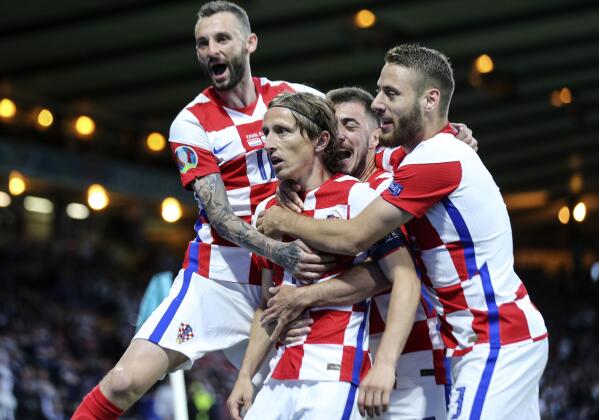 Croatia's Luka Modric is celebrated after scoring his side's second goal during the Euro 2020 soccer championship group D match between Croatia and Scotland at the Hampden Park Stadium in Glasgow, Tuesday, June 22, 2021.(Robert Perry/Pool via AP))