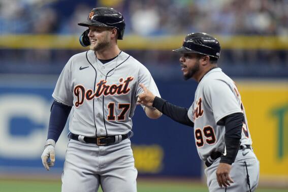 Detroit Tigers' Austin Meadows (17) celebrates with first base coach Alfredo Amezaga (99) after hitting a single off Tampa Bay Rays starting pitcher Shane McClanahan during the fourth inning of a baseball game Thursday, March 30, 2023, in St. Petersburg, Fla. (AP Photo/Chris O'Meara)