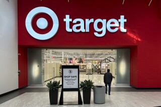 FILE - A person heads into a Target store Thursday, Jan. 11, 2024, in Lakewood, Colo. The company is slated to announce fourth-quarter financial results on Tuesday, March 5, 2024, hours before it holds its annual meeting with investors and analysts. The results and executive comments should offer more clues on shopper behavior in a still tough economic environment. (AP Photo/David Zalubowski, File)