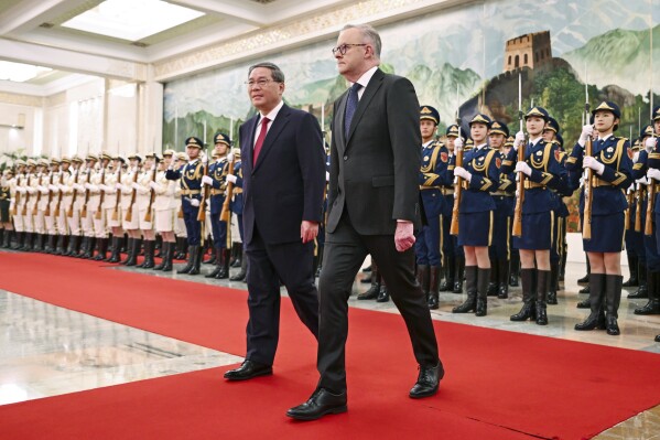 Australian Prime Minister Anthony Albanese, right, walks with Chinese Premier Li Qiang during a ceremonial welcome at the Great Hall of the People in Beijing, China, Tuesday, Nov. 7, 2023. Albanese is on the final day of a three-day visit to China. (Lukas Coch/AAP Image via AP)