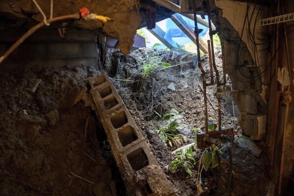 The foundation of a house remains crumbled in Highland Falls, N.Y., Aug. 10, 2023, following severe flooding throughout the Hudson Valley. New York could soon require people selling their homes to disclose whether their properties have been flooded or are at risk for future flooding. (AP Photo/Mary Conlon)