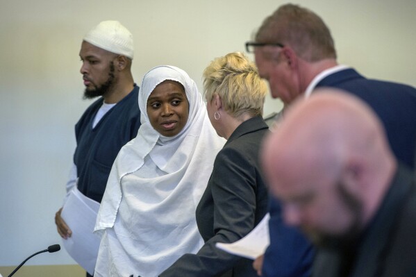 FILE - Siraj Ibn Wahhaj, from left, and Jany Leveille talk with with attorneys Kelly Golightley and Tom Clark after a hearing on a motion to dismiss in the Taos County Courthouse, Wednesday, Aug. 29, 2018. A U.S. district judge in New Mexico has unsealed a plea agreement for Jany Leveille, one of the key defendants in a federal terrorism and kidnapping case that stemmed from the search for a toddler who went missing from Georgia in 2017. The documents were made public Thursday, Oct. 19, 2023, just days after a jury convicted four other family members in what prosecutors had called a “sick end-of-times scheme.” (Eddie Moore/The Albuquerque Journal via AP, Pool, File)