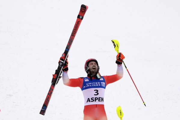 Switzerland's Loic Meillard celebrates after his victory in a men's World Cup slalom skiing race, Sunday, March 3, 2024, in Aspen, Colo. (AP Photo/Robert F. Bukaty)