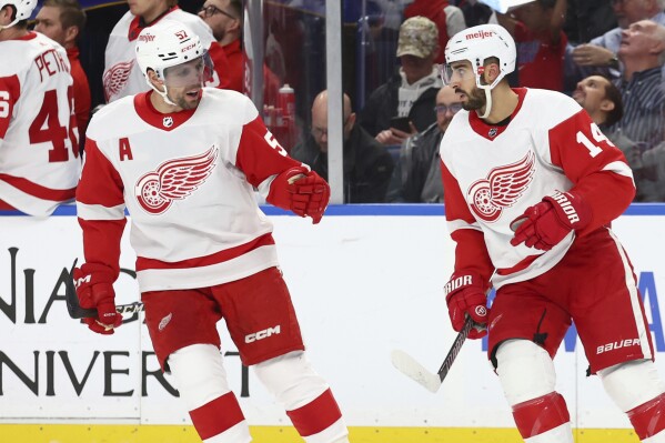 Detroit Red Wings center Robby Fabbri (14) celebrates his goal with left wing David Perron (57) during the first period of an NHL hockey game Tuesday, Dec. 5, 2023, in Buffalo, N.Y. (AP Photo/Jeffrey T. Barnes)
