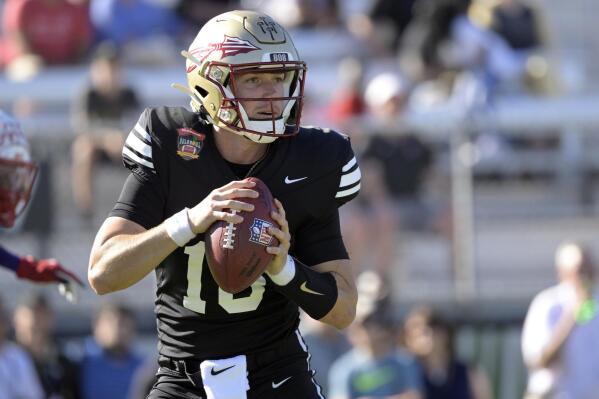 FILE - Team Aina quarterback McKenzie Milton (10), of Florida State, looks for a receiver during the second half of the Hula Bowl NCAA college football game against Team Kai, Saturday, Jan. 15, 2022, in Orlando, Fla. Former UCF quarterback McKenzie Milton, who came back from a gruesome leg injury in 2018 to play another season of college football for Florida State two years later, has been hired by Tennessee to be an offensive analyst. (AP Photo/Phelan M. Ebenhack, File)