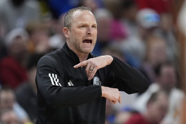 Drake head coach Darian DeVries is seen on the sidelines during the second half of a first-round college basketball game against Washington State in the NCAA Tournament Thursday, March 21, 2024, in Omaha, Neb. (AP Photo/Charlie Neibergall)