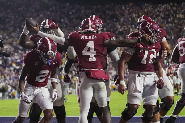 Alabama quarterback Jalen Milroe (4) celebrates a touchdown carry in the second half an NCAA college football game against LSU in Baton Rouge, La., Saturday, Nov. 9, 2024. (AP Photo/Gerald Herbert)
