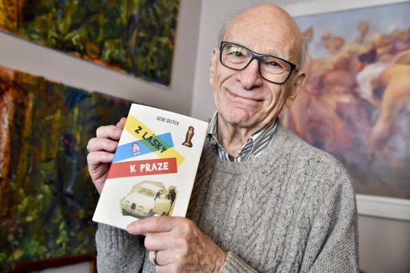 FILE - In this February 20, 2018 file photo the American director and animated film producer Gene Deitch poses for the photographer with his book of memories 'For the Love of Prague' in Prague, Czech Republic. Deitch, living in Prague with his Czech wife, animator and producer Zdenka Najmanova, has died at the age of 95 years. Deitch directed Czechoslovak-American animated film 'Munro' that won an Oscar for the Best Animated Short Film in 1961. (Vit Simanek/CTK via AP)