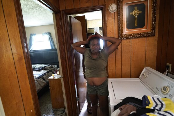 Patricia Bingo Lavergne reacts as she sees the inside of her damaged home for the first time in Lake Charles, La., after returning home after evacuating from Hurricane Laura, Sunday, Aug. 30, 2020. (AP Photo/Gerald Herbert)