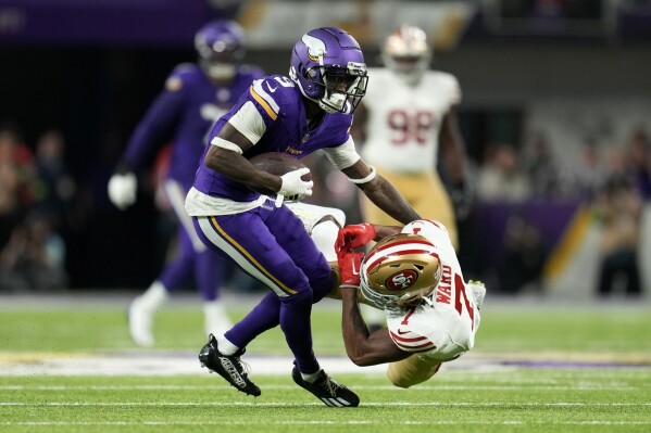 Minnesota Vikings wide receiver Jordan Addison (3) breaks a tackle by San Francisco 49ers cornerback Charvarius Ward (7) during a 60-yard touchdown reception in the first half of an NFL football game, Monday, Oct. 23, 2023, in Minneapolis. (AP Photo/Abbie Parr)