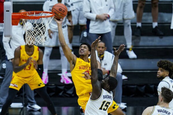 Maryland guard Aaron Wiggins (2) shoots over Michigan guard Chaundee Brown (15) in the first half of an NCAA college basketball game at the Big Ten Conference tournament in Indianapolis, Friday, March 12, 2021. (AP Photo/Michael Conroy)