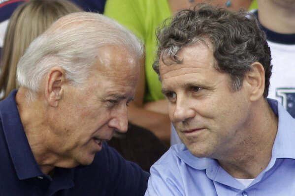 FILE – In this Sept. 5, 2011 file photo, Vice President Joe Biden, left, speaks with Sen. Sherrod Brown, D-Ohio, at an AFL-CIO Labor Day picnic at Coney Island in Cincinnati. Brown, Ohio's most prominent Democrat, endorsed Biden for president on Tuesday, April 7, 2020, with his state's extended primary three weeks away. (AP Photo/Al Behrman, File)