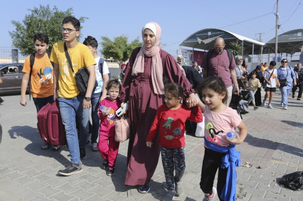 Palestinians cross to the Egyptian side of the border crossing with the Gaza Strip Wednesday, Nov. 1, 2023. in Rafah Wednesday, Nov. 1, 2023. (AP Photo/Hatem Ali)