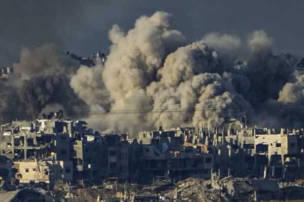 FILE - Smoke rises following an Israeli bombardment in the Gaza Strip, as seen from southern Israel, Saturday, Dec. 16, 2023. srael is sending top legal minds, including a Holocaust survivor, to The Hague this week to counter allegations that it is committing genocide against Palestinians in Gaza. (AP Photo/Ariel Schalit, File)