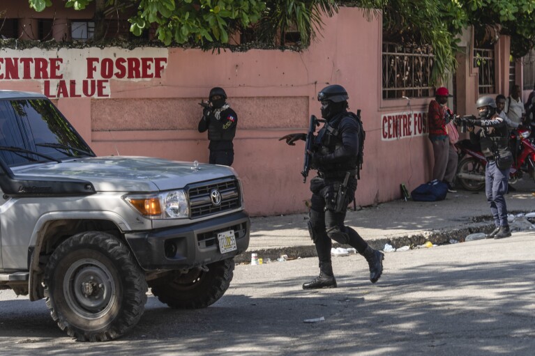 Police stop at a car to inspect in Port-au-Prince, Haiti, Monday, April 22, 2024. Haiti's health system has long been fragile, but it's now nearing total collapse after gangs launched coordinated attacks on Feb. 29, targeting critical state infrastructure in the capital and beyond. (AP Photo/Ramon Espinosa)