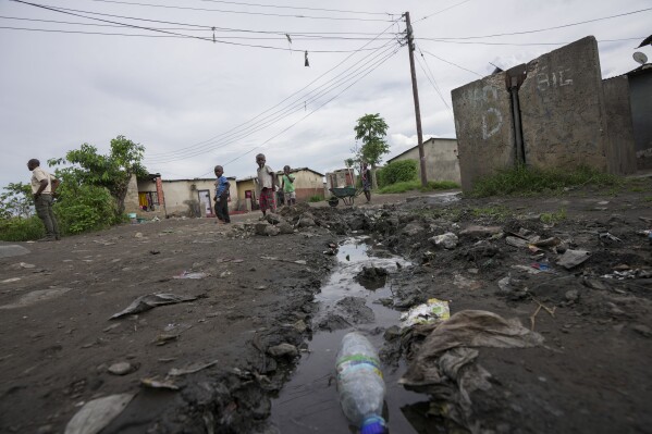 Children play near stagnant pools of water in Lilanda township in Lusaka, Zambia, Saturday March 9, 2024. (AP Photo/Tsvangirayi Mukwazhi)