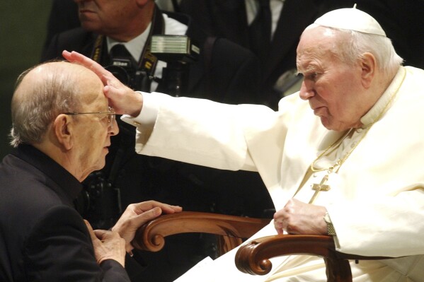 FILE - Pope John Paul II gives his blessing to late father Marcial Maciel, founder of Christ's Legionaries, during a special audience the pontiff granted to about four thousand participants of the Regnum Christi movement, at the Vatican, on Nov. 30, 2004. The recently-opened archives of Pope Pius XII have shed new light on claims the World War II-era pope didn't speak out about the Holocaust. But they're also providing details about another contentious chapter in Vatican history: the scandal over the founder of the Legionaries of Christ. (ĢӰԺ Photo/Plinio Lepri, File)