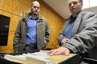 FILE - Retire Congress North Dakota Chairman Jared Hendrix, left, and U.S. Term Limits National Field Director Scott Tillman look over petitions they submitted for a North Dakota congressional age limit ballot initiative on Friday, Feb. 9, 2024, at the state Capitol in Bismarck, N.D. North Dakota Secretary of State Michael Howe's office on Friday, March 15, announced the initiated measure will appear on the June 11 election ballot for voters to decide. (AP Photo/Jack Dura, File)