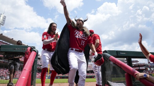 Cincinnati Reds' Nick Senzel (15) reacts as he enters the dugout after hitting a two-run home run against the Arizona Diamondbacks during the second inning of a baseball game, Sunday, July 23, 2023, in Cincinnati. (AP Photo/Jeff Dean)