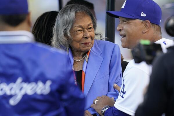 FILE - Los Angeles Dodgers' manager Dave Roberts, right, greets Rachel Robinson, wife of Jackie Robinson, before a baseball game between the Cincinnati Reds and the Los Angeles Dodgers in Los Angeles, Friday, April 15, 2022. Baseball's All-Stars gathered on the field before Tuesday night's, July 19, 2022,  game at Dodger Stadium to honor Rachel Robinson on her 100th birthday. (AP Photo/Ashley Landis, File)