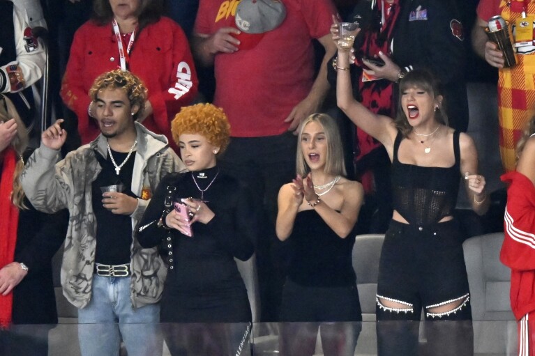 Ice Spice, Ashley Avignone and Taylor Swift cheer before the NFL Super Bowl 58 football game between the San Francisco 49ers and the Kansas City Chiefs on Sunday, Feb. 11, 2024, in Las Vegas.  (AP Photo/David Becker)