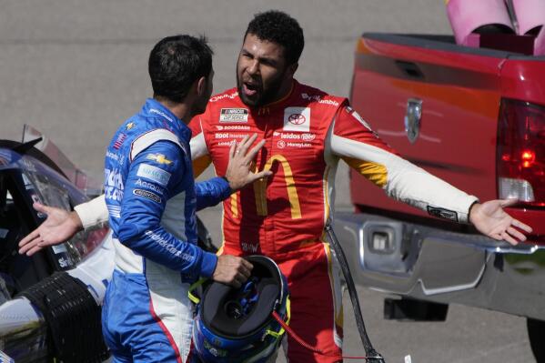 Bubba Wallace, right, argues with Kyle Larson after the two crashed during a NASCAR Cup Series auto race Sunday, Oct. 16, 2022, in Las Vegas. (AP Photo/John Locher)