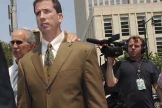 FILE - In this July 29, 2008, file photo, former NBA referee Tim Donaghy exits Brooklyn federal court following his sentencing after pleading guilty to federal charges that he took payoffs from a professional gambler for inside tips on games. The disgraced former NBA referee is back, and again this time he’s fixing the result, only with his employer’s permission. Donaghy made his debut for Major League Wrestling this week in nefarious fashion. (AP Photo/Louis Lanzano, File)