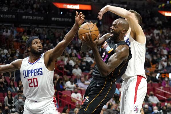 Los Angeles Clippers forward Justise Winslow (20) and center Isaiah Hartenstein, right, defend against Miami Heat center Dewayne Dedmon, center, during the first half of an NBA basketball game, Friday, Jan. 28, 2022, in Miami. (AP Photo/Lynne Sladky)