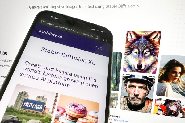 In this picture, the desktop and mobile websites for Stable Diffusion are seen, Tuesday, Oct. 24, 2023, in New York. Computer-generated child sexual abuse images made with artificial intelligence tools like Stable Diffusion are starting to proliferate on the internet and are so realistic that they can be indistinguishable from photographs depicting actual children, according to a new report. (AP Photo/John Minchillo)