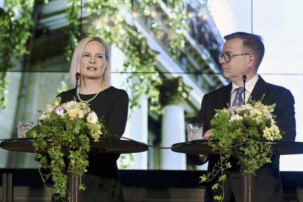 The new Government of Finland led by Prime Minister Petteri Orpo, right, and the new Minister of Finance Riikka Purra hold a press conference in Helsinki, Finland Tuesday, June 20, 2023. (Jussi Nukari/Lehtikuva via AP)