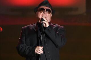 FILE - In this June 18, 2015 file photo, Van Morrison performs at the 46th annual Songwriters Hall of Fame Induction and Awards Gala in New York. Northern Ireland’s health minister is suing Van Morrison after the singer called him “very dangerous” for his handling of coronavirus restrictions, it was announced Monday, Nov, 8 2021. The Belfast-born singer opposes restrictions to curb the spread of the virus, and has released several songs criticizing lockdowns. (Photo by Evan Agostini/Invision/AP, File)