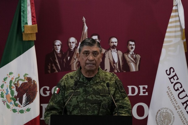 FILE - Mexican Defense Secretary Luis Cresencio Sandoval announces the arrest of Ovidio during a press conference in Mexico City, on Jan. 5, 2023. The U.S. government thanked Mexico for arresting a hyper violent alleged Sinaloa cartel security chief, but according to details released Friday, Nov. 24, 2023 the arrest of suspect Nestor Isidro Pérez Salas this week may have been highly personal for the Mexican army. Sandoval said Pérez Salas had ordered a 2019 attack on an unguarded apartment complex where soldiers’ families lived. (AP Photo/Eduardo Verdugo, File)