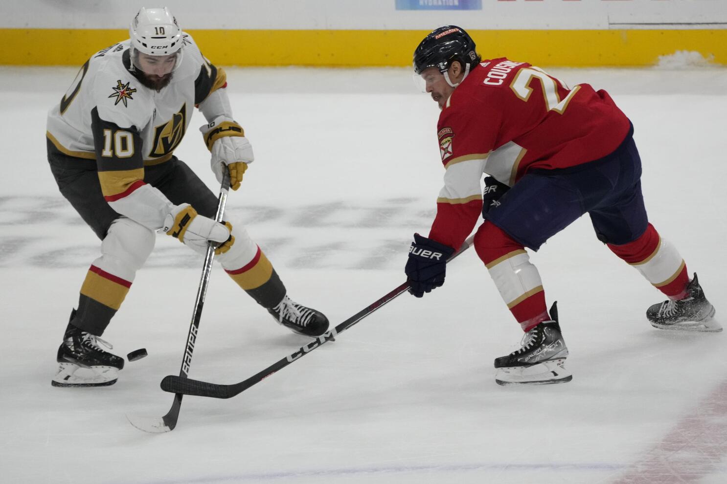 Vegas Golden Knights' Nick Cousins, left, gets past Calgary Flames