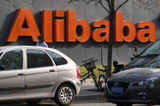 FILE - The Alibaba logo is seen outside a building in Beijing on Nov. 16, 2021. Alibaba Group Holding on Wednesday, Feb. 7, 2024, approved an additional $25 billion addition to its share buyback program, amid lower-than-expected sales revenue for the last quarter of 2023.(AP Photo/Ng Han Guan, File)