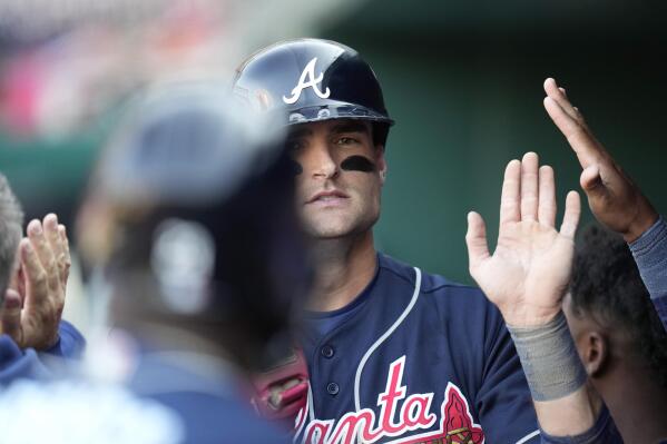 Orlando Arcia of the Atlanta Braves stands in the dugout during
