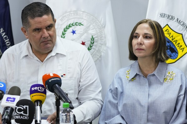 Panama's Security Minister Juan Pino, left, and Panama's National Immigration Authority Director Samira Gozaine listen to questions during a press conference where they announced migration measures in Panama City, Friday, Sept. 8, 2023. Panama will increase infrastructure in the jungle area along its shared border with Colombia known as the Darien Gap — as well as ramp up deportations — to contain a record-breaking flow of migrants passing through there this year, Gozaine said Friday. (AP Photo/Arnulfo Franco)