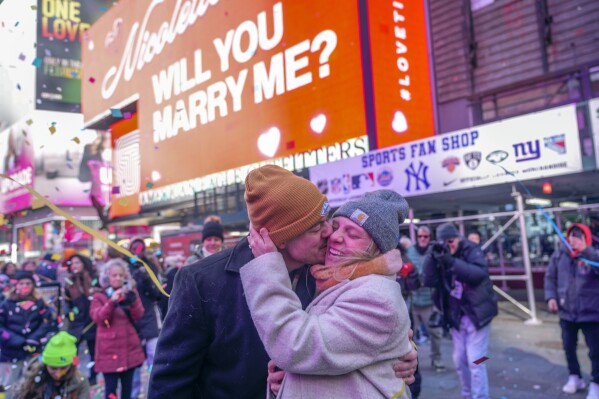 Justin Shady, left, kisses Nicolette Miller after she accepted his marriage proposal during a Love in Times Square event, Wednesday, Feb. 14, 2024, in New York's Times Square. (AP Photo/Mary Altaffer)