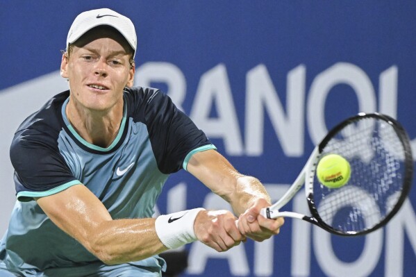 Jannik Sinner, of Italy, plays a shot to Andrey Rublev, of Russia, during their quarterfinal match at the National Bank Open tennis tournament in Montreal, Saturday, Aug. 10, 2024. (Graham Hughes/The Canadian Press via AP)